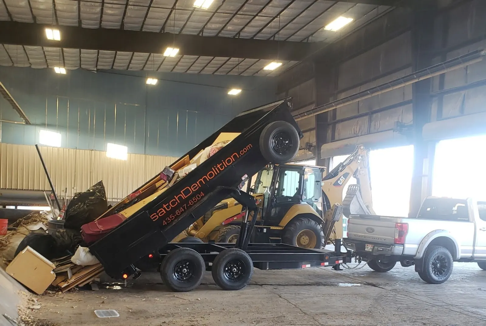 Wasatch Demolition dump trailer being loaded with demolition debris at a warehouse job in Park City, UT