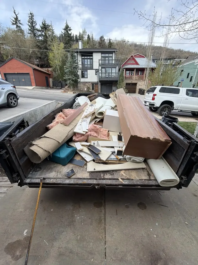 Dump trailer loaded with interior demolition debris in Old Town Park City, UT